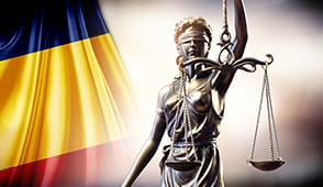 The Romanian flag and justice statue.