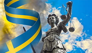 The Sweden flag and justice statue.