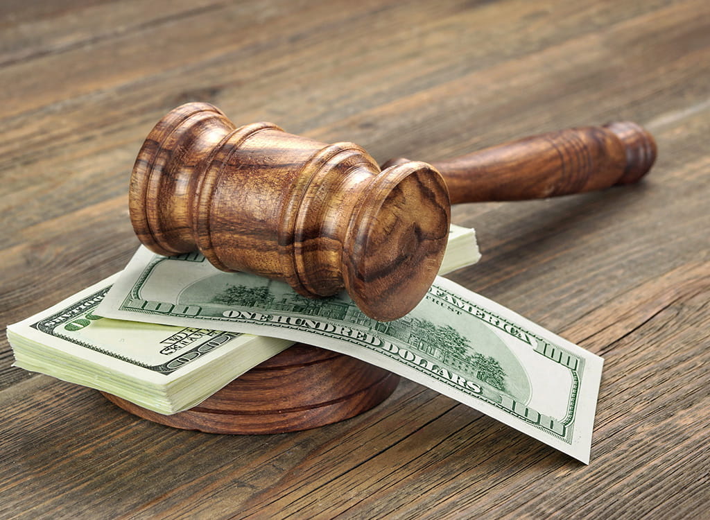 A Wooden Gavel on A Pile of Money