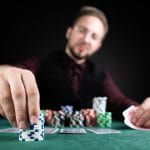 A Person Playing Poker at A Casino