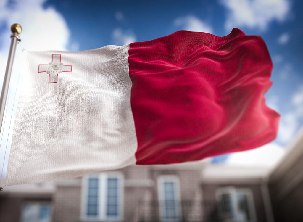 The Waving Flag of Malta on A Blue Background