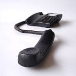 A Black Telephone On A White Background