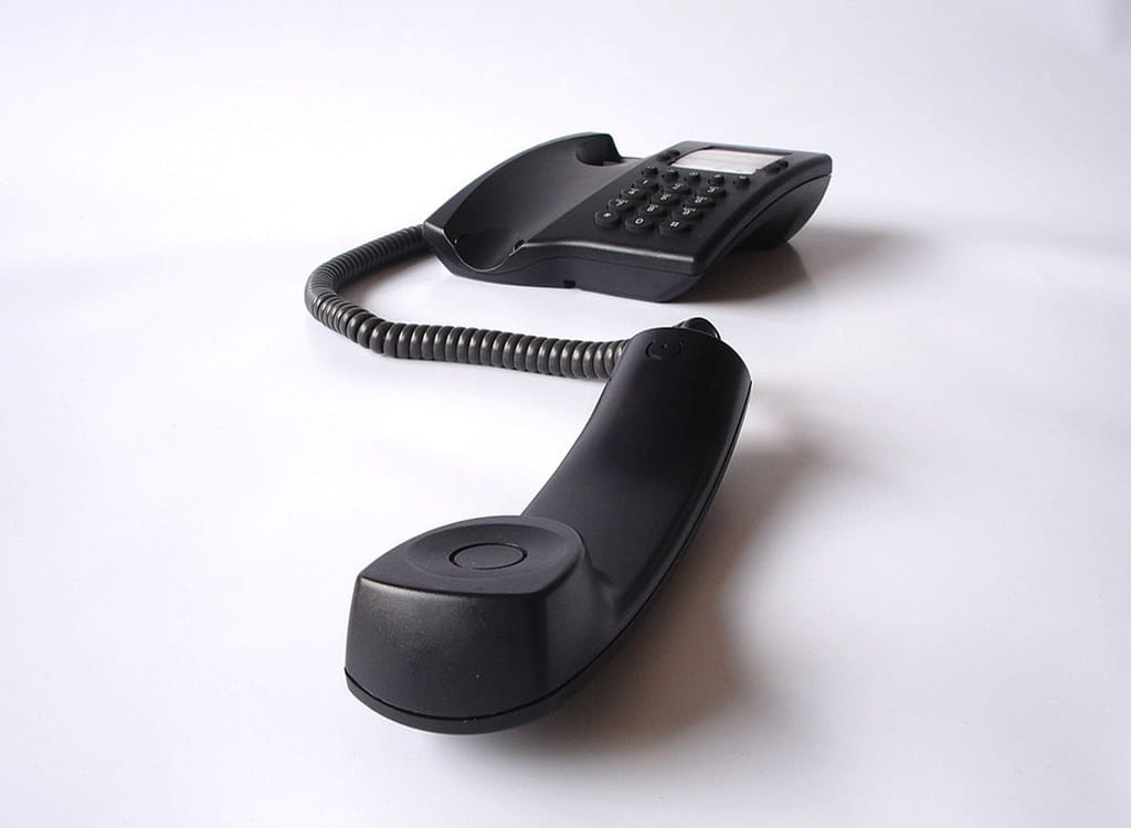 A Black Telephone On A White Background 