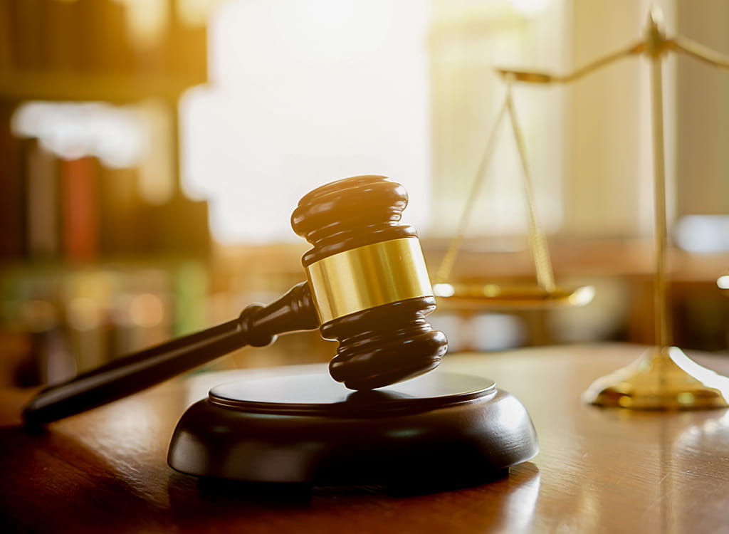 A Dark Wooden Gavel On A Black Background 