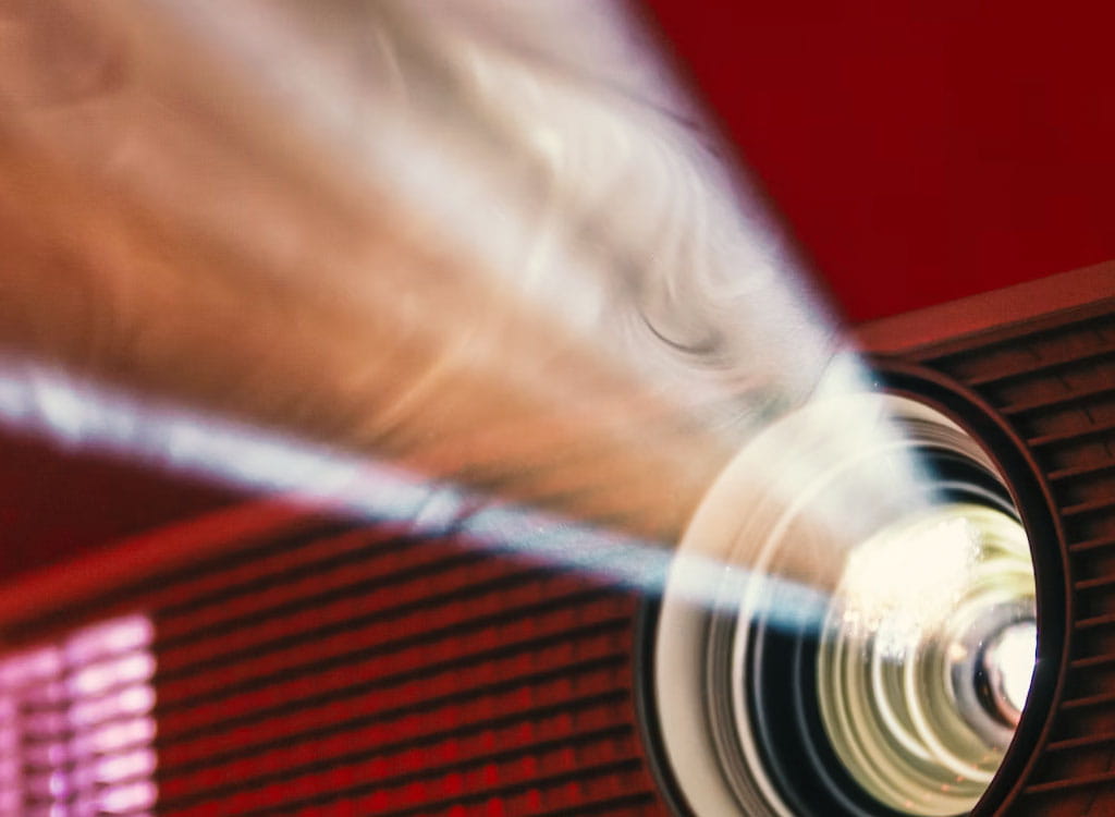 A Movie Projector On A Red Background  