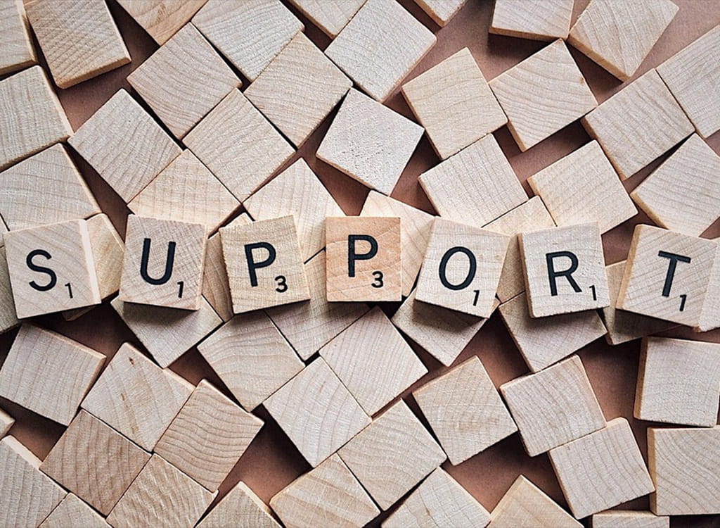 The Word Support Written with Wooden Letter Tiles 