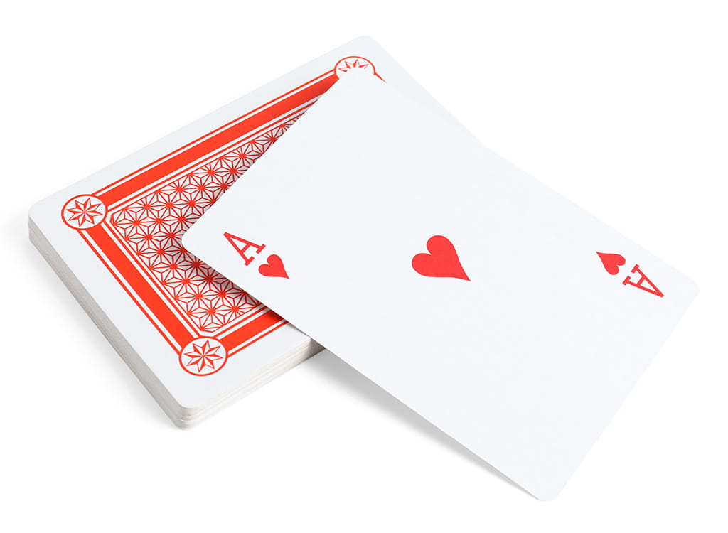 A White Ace of Hearts Card Over A Pile of Cards