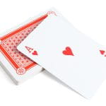 A White Ace of Hearts Card Over A Pile of Cards