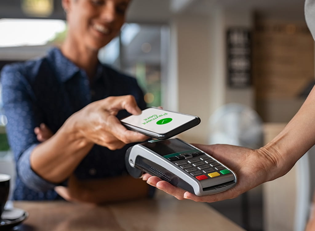 A Woman Using Her Phone to Pay Online